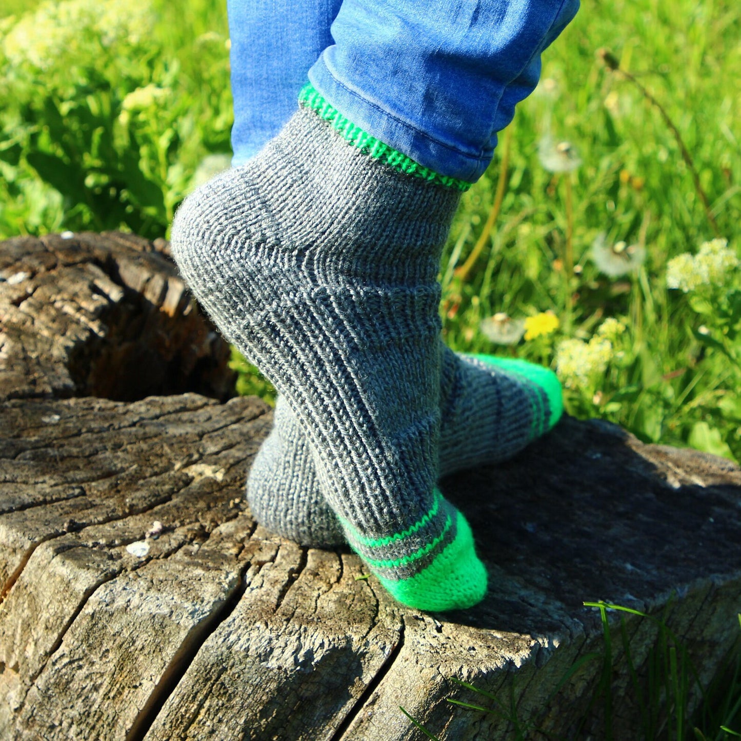 Unisex hand-knitted socks in gray with vibrant green accents