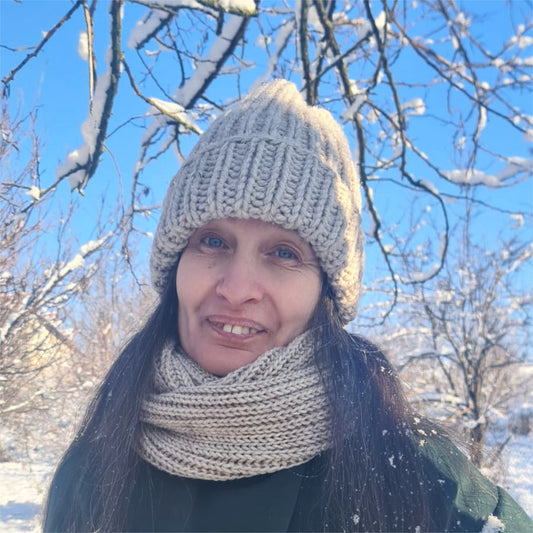 2 piece set of beige knitted hat and infinity scarf